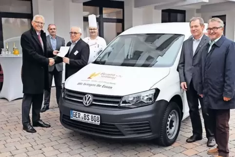 Peter Dudenhöffer von der Sparkasse übergibt Geschäftsführer der Stiftung, Wolfgang Kuhn, die Fahrzeugpapiere.