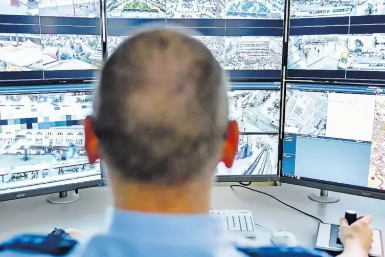 Der Polizist vor den Bildschirmen im Polizeipräsidium soll mithilfe von Computertechnik verdächtige Bewegungen erkennen.