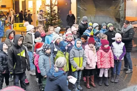 Die Schwegenheimer Grundschüler trotzten auf dem Weihnachtsmarkt dem schlechten Wetter mit Gesang.