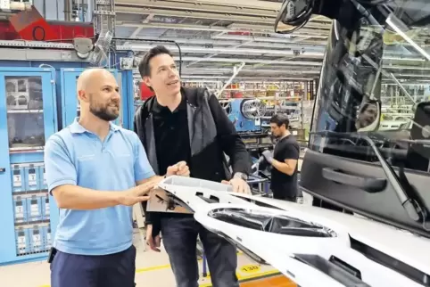 Treffen am Montage-Band der Lkw-Produktion: Stefan Tewis (links) erklärt Personalleiter Matthias Herwarth den Fahrerhaus-Innenau