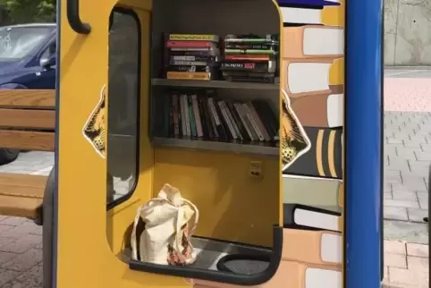 Der untere Teil in der Tür der zur Bücher-Ecke umfunktionierten Telefonzelle auf dem Pirmasenser Münzplatz fehlt.  Foto: gana
