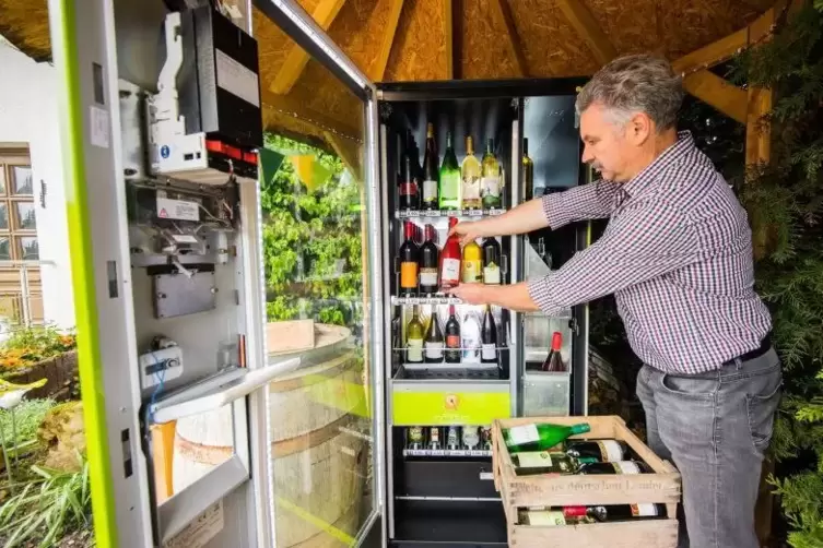 Der Bockenheimer Winzer Volker Griebel befüllt seinen Automaten mit eigenem Wein Foto: Andreas Arnold/dpa 