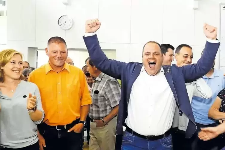 Hände hoch, Jubelschrei: Patrick Fassott freut sich über den Wahlsieg. Hinter ihm (links im Bild) steht sein Herausforderer Stef