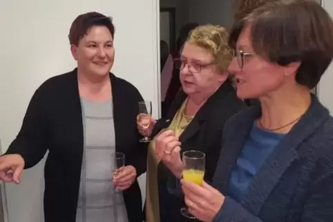 Betrachten Dokumente und Bilder aus der Geschichte des Gebäudes: (von links) Pfarrerin Bettina Beyerle, Pastoralreferentin Sabin