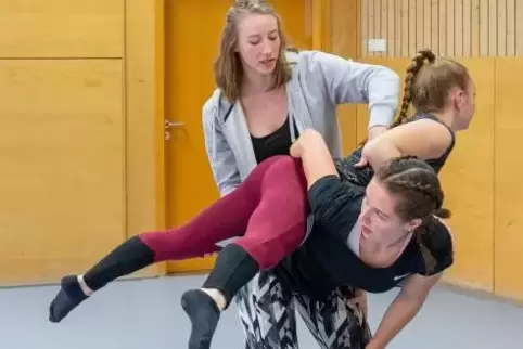 Jasmin Glahn (in der grauen Weste) zeigt Celine Radke (oben) und Isabelle Veit die richtige Haltung in den Übungen für eine Kür.