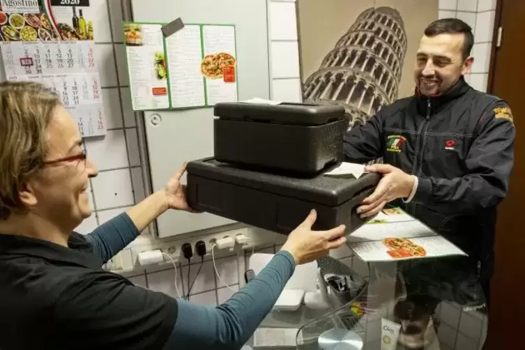 Ein leckeres Mahl ohne Arbeit, das bietet der Otterberger Heimservice Pisa: Marlene di Fede &uuml;bergibt Fahrer Werner Bolzer zwei B