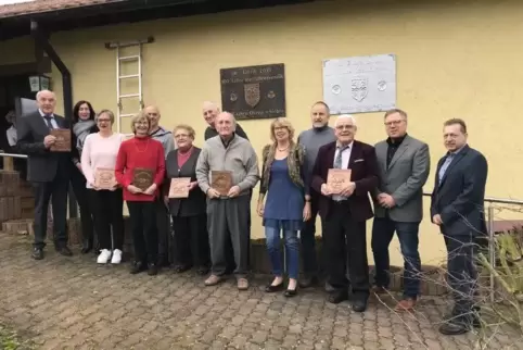 Langjährige Mitglieder des RVE Rodenbach vor den Gedenktafeln am Radlerheim, von links Norbert Schindler, Maretina Diehl-Becker,