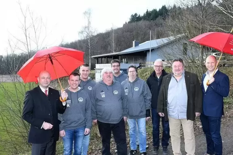 Sparkassen-Chef Günther Bolinius (links) mit Vertretern von TuS und Ortsgemeinde vor dem sanierten Sportheim, dem die Spende des
